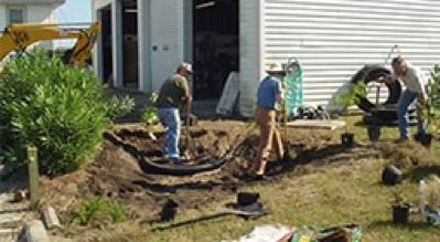 several men installing a rain garden
